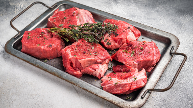 Beef tenderloin medallions on a tray.