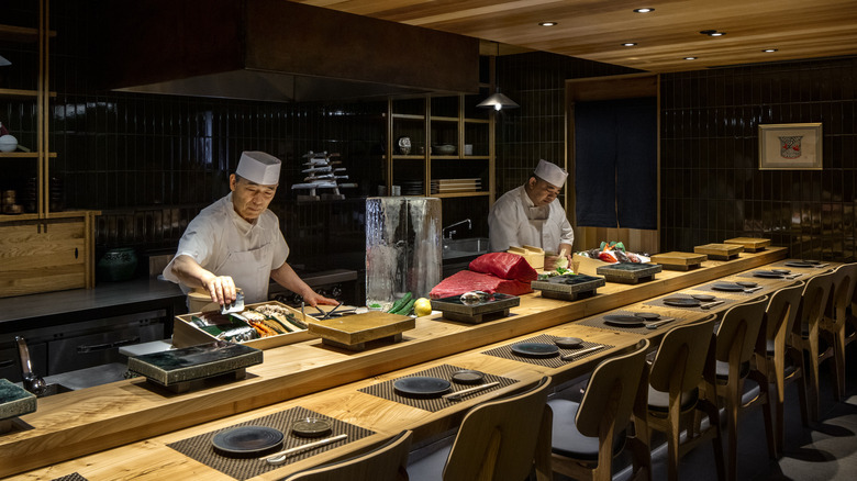 Counter in front of kitchen, where chefs are working, inside Kizaki