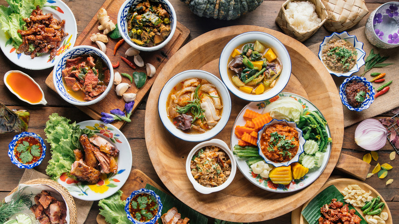 Various Thai food dishes on a table