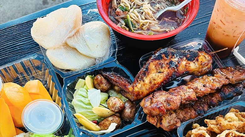 Plates of takeaway food from the Wat Thai Food Market
