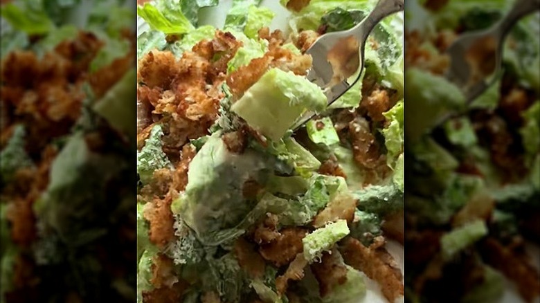 Onion ring caesar salad with a fork