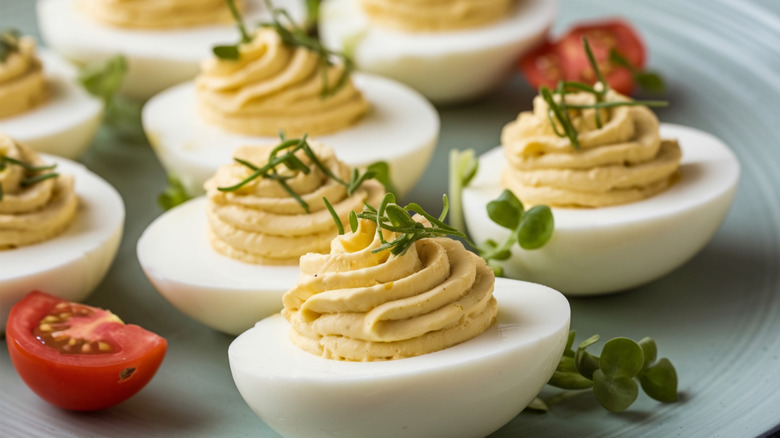 Deviled eggs topped with herbs
