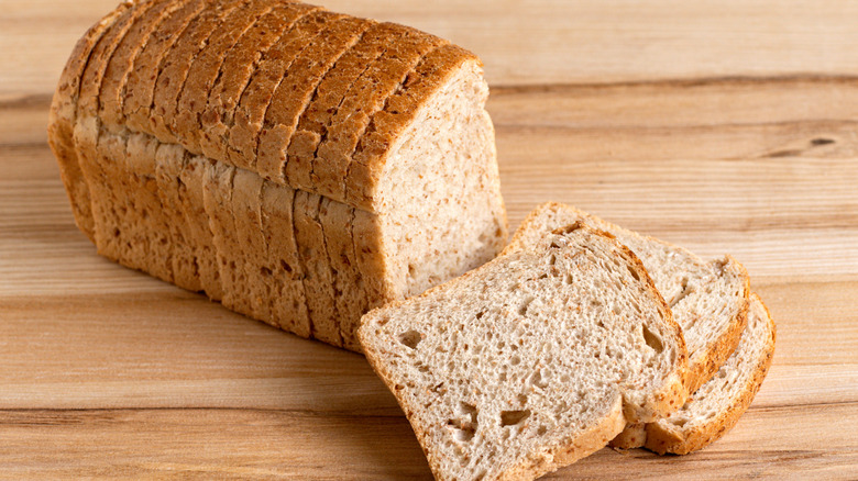 Sliced wheat bread on a wooden background