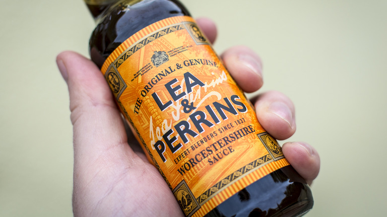 hand holding Lea & Perrins Worcestershire Sauce