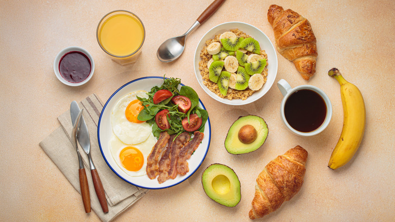 A healthy breakfast including eggs, avocado, bananas and oats.