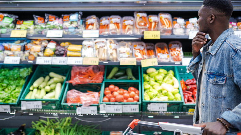 Shopper looking at vegetables in the grocery store
