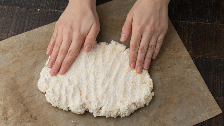 Person kneading a cottage cheese pizza dough
