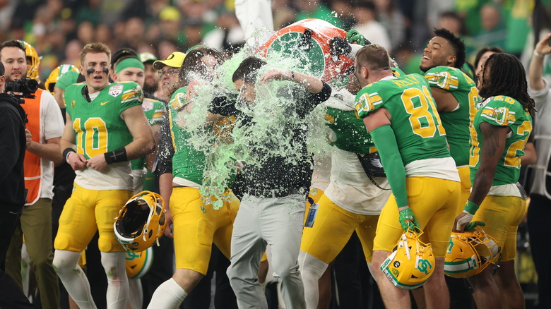 football players shower coach with Gatorade