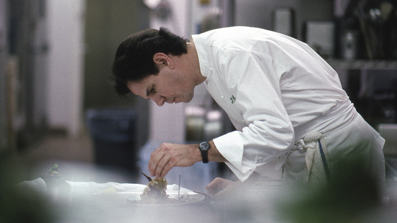 Thomas Keller cooking in restaurant
