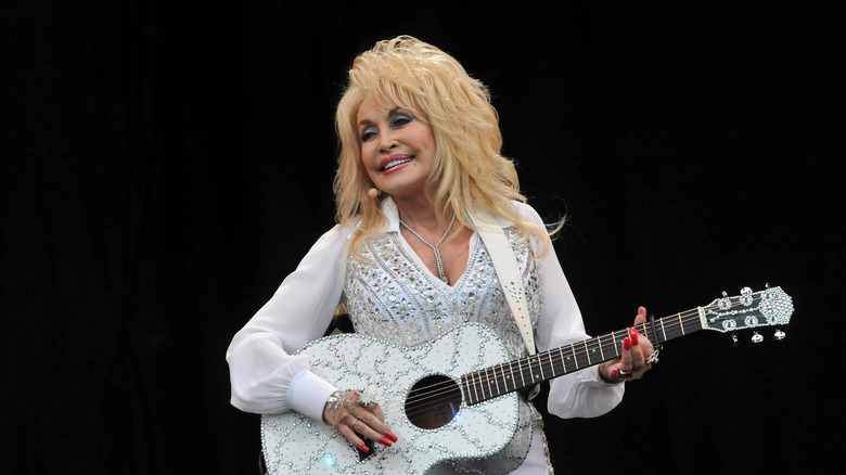 Dolly Parton playing guitar