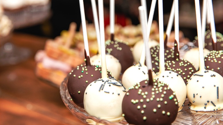Cake pops covered in white and milk chocolate and sprinkles