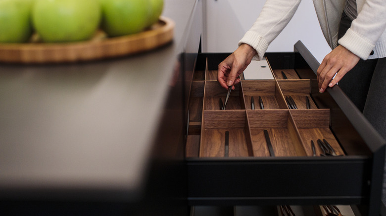 Person opening a kitchen drawer