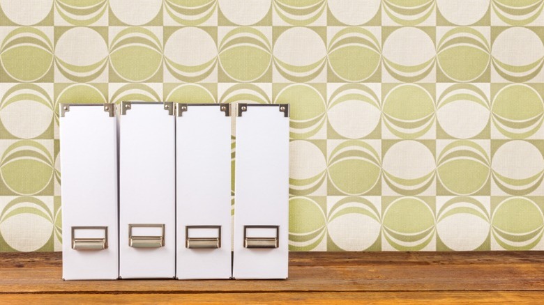 White file or magazine holders on a kitchen shelf