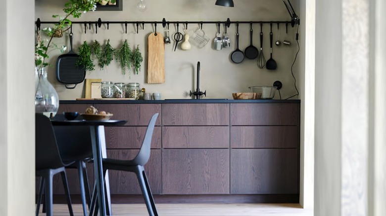 pots and pans hanging on an IKEA rail in a kitchen