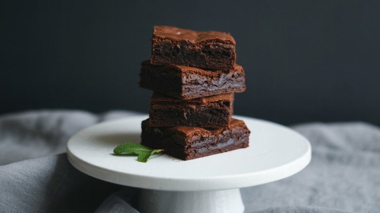 A stack of brownies on a raised serving dish