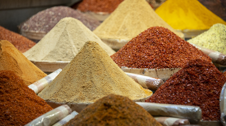 mounds of spices at an outdoor market