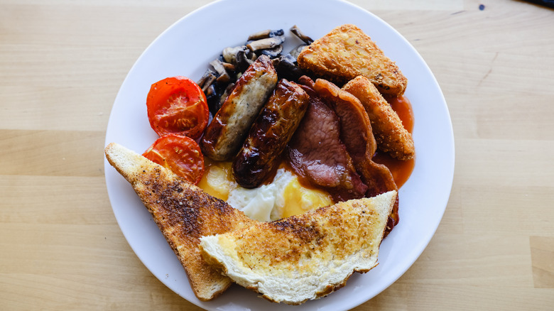 a full English breakfast on a white plate