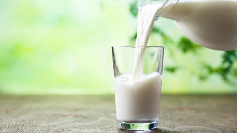 Milk being poured into a glass from a bottle