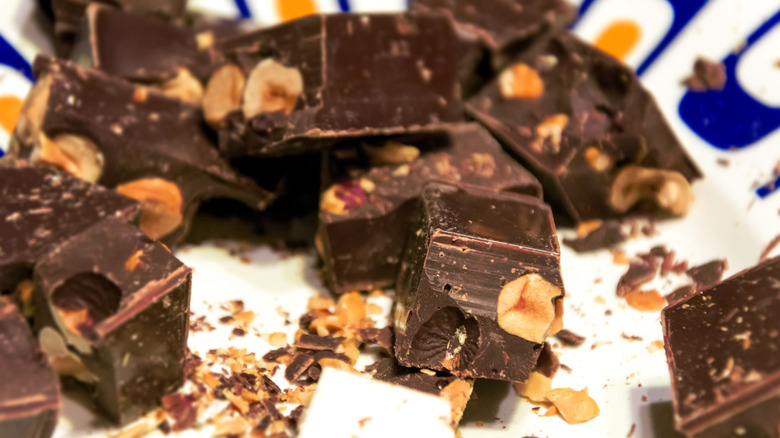 A stack of gianduja chocolate with whole hazelnuts inside.