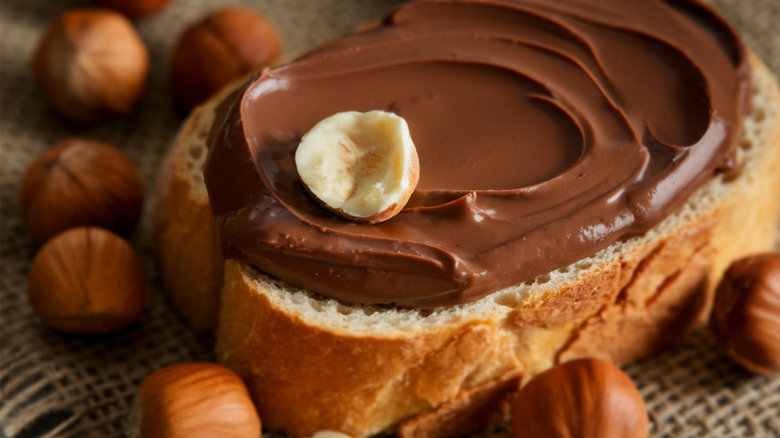 A slice of bread with gianduja spread on it.
