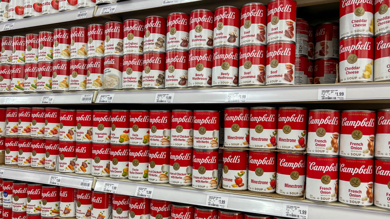 Campell's condensed soup cans on a shelf at a grocery store