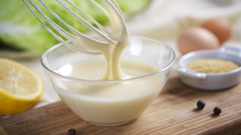 Preparation of mayonnaise in the home kitchen on a sunny day