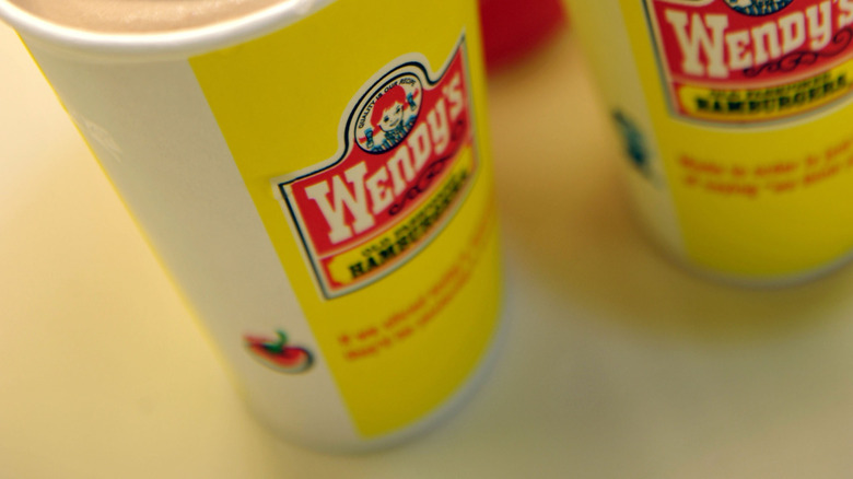 A close-up of Wendy's Frostys in a yellow cup