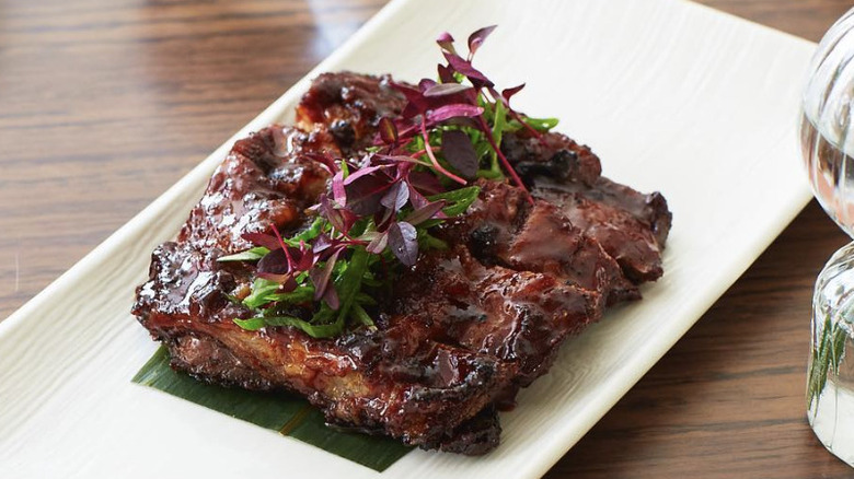 Goat ribs on white plate