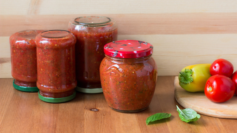 Tomato sauce with herbs in mason jars
