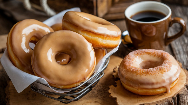 A wire basket full of glazed donuts