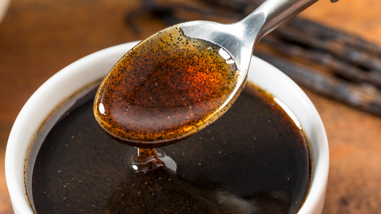 A spoonful of vanilla extract with a syrupy consistency
