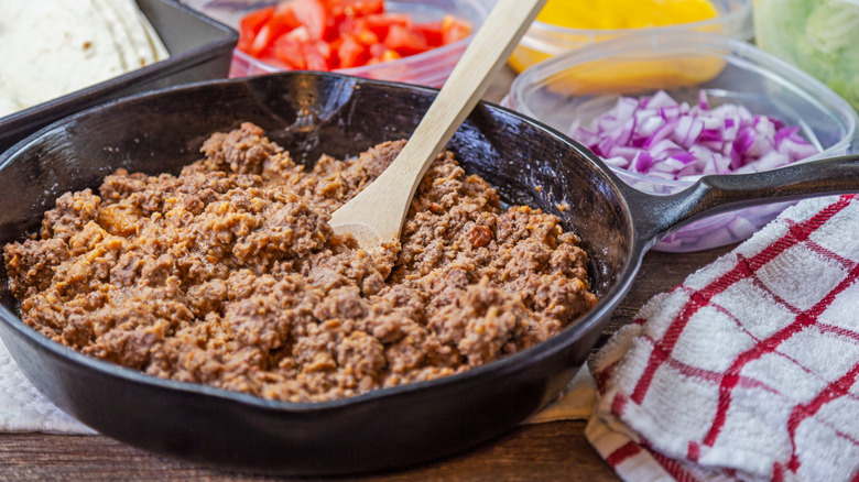 Ground beef browning in cast iron pan