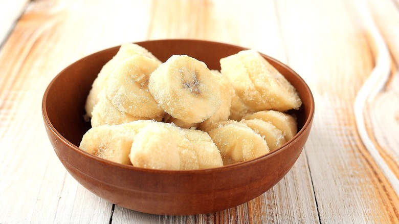 Frozen banana slices in a wooden bowl