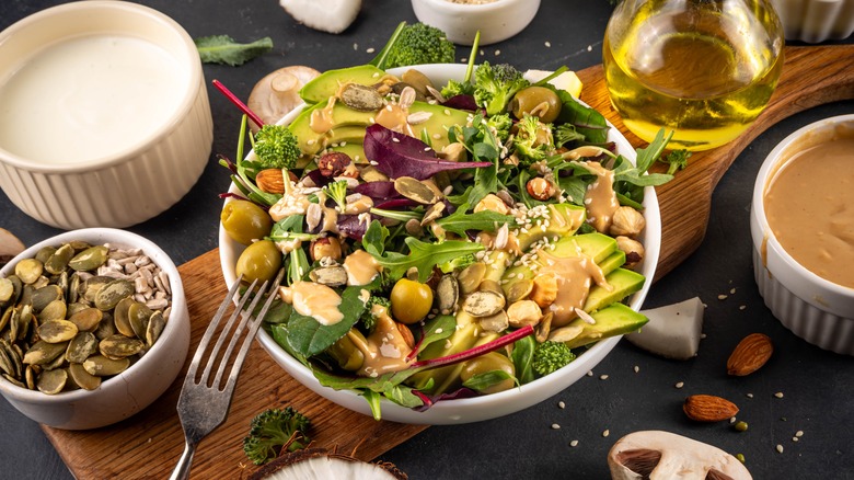 a bowl of salad with peanut butter dressing