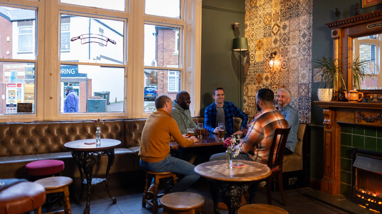Five men drinking beer at a local pub
