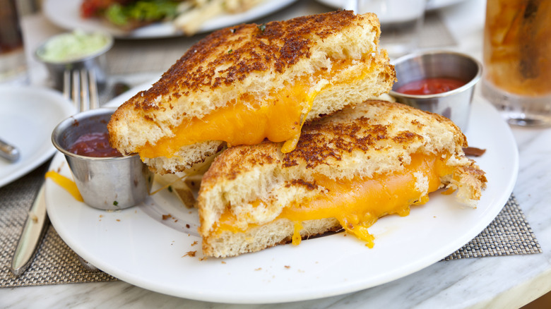 A gourmet grilled cheese at a restaurant with sauces