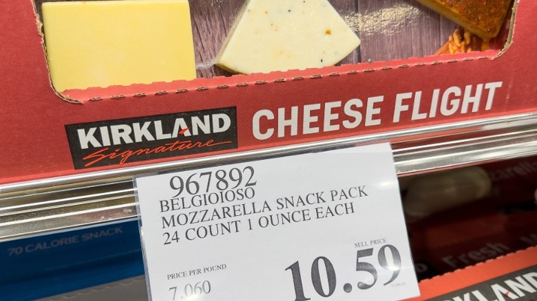 A cheese flight on a shelf at Costco with the price tag showing.