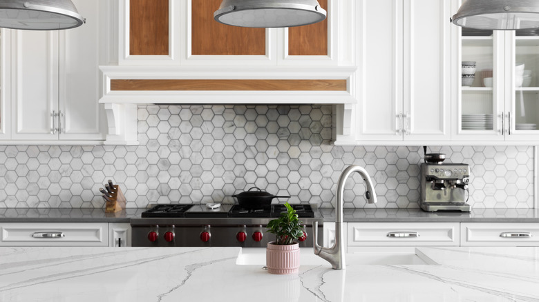a cool, white kitchen with a patterned backsplash