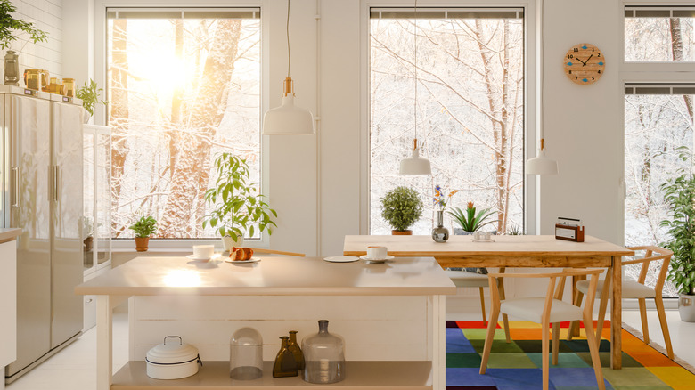 A set of bright kitchen windows are uncovered.