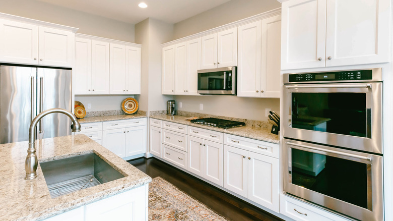 clutter-free kitchen area showing the fridge, cooktop, and sink