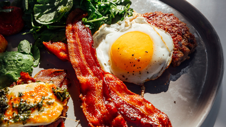 Breakast platter with eggs, meat, and greens