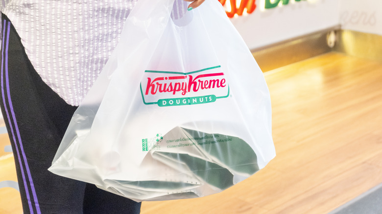 Person holding Krispy Kreme bag
