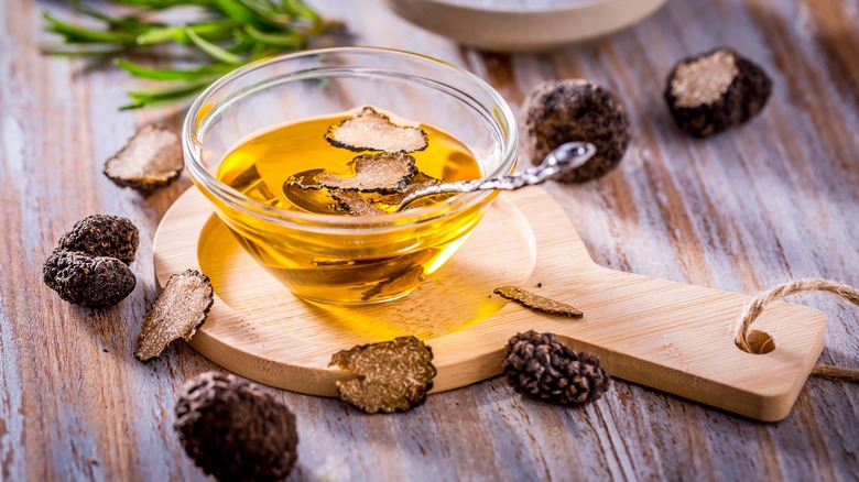 truffle oil with shaved truffles in small glass bowl