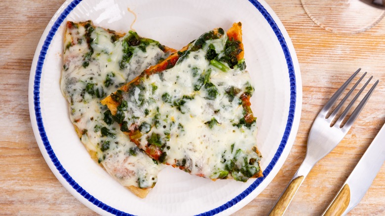 Pizza with spinach under cheese