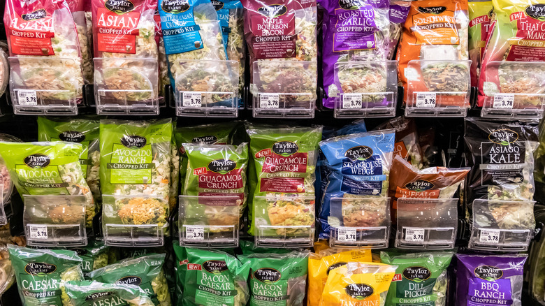 Rows of bagged salad mixes at the grocery store