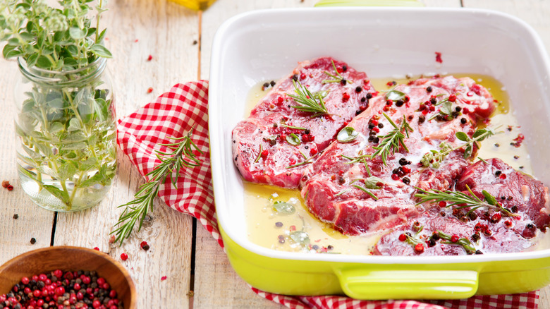 Steaks marinating in a dish