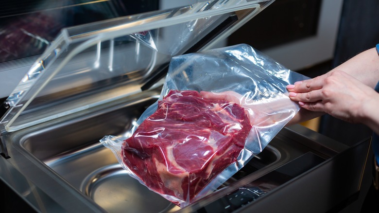 Placing steak in sous-vide machine