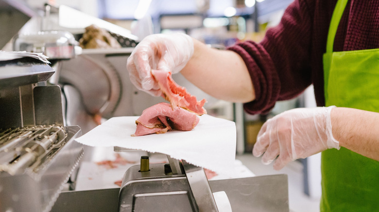roast beef sliced behind deli counter