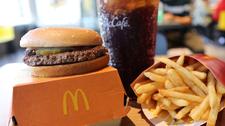 A McDonald's Quarter Pounder meal with fries and a soda.