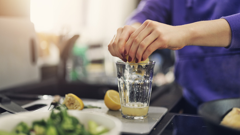 Person squeezing lemon juice